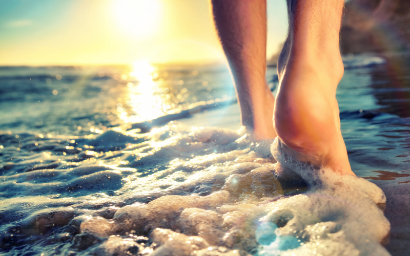 bare feet in the ocean